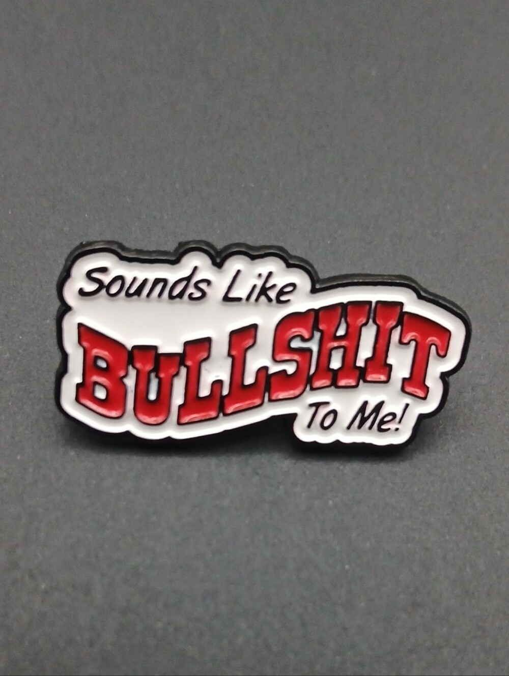 This is a "Sounds Like Bullshit To Me" enamel lapel pin